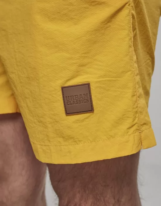 Мъжки плувни шорти Urban Classics Block в жълт цвят, Къси панталони - Hoodstyle.bg